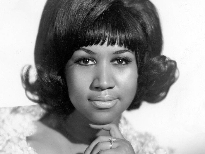 Close-up black and white portrait of a female celebrity with styled hair, highlighting unique encounters with celebs.