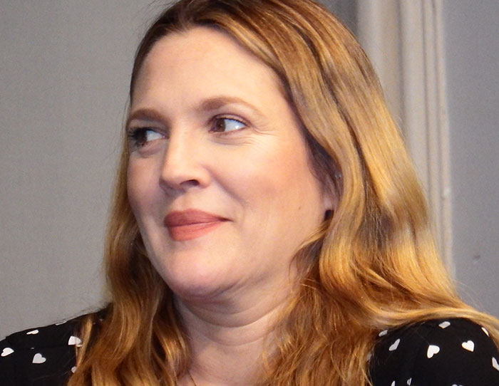 Woman with long blonde hair smiling and looking sideways, illustrating stories of strangers crossing paths with celebs