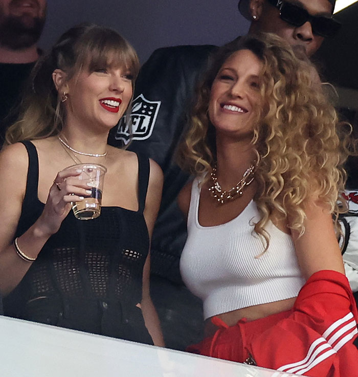 Taylor Swift and Blake Lively smiling at an event, highlighting alleged blackmail with personal texts amid feud.