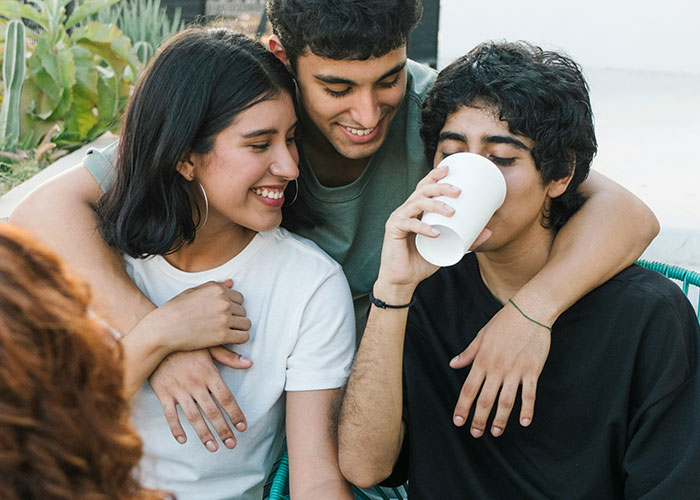 Group of friends enjoying time together, featuring guy always bringing BFF to dates and sharing unhinged truth moments.