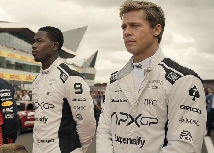 Brad Pitt wearing a racing suit at a motorsport event, related to Brad Pitt divorce battle news.