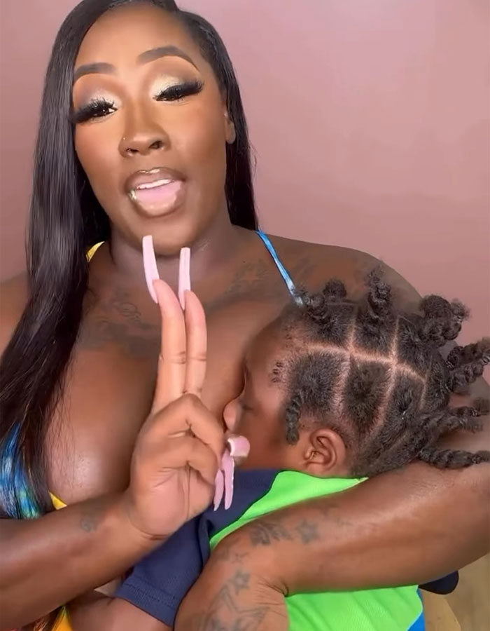 Woman breastfeeding her child, addressing netizens, highlighting the controversy of publicly breastfeeding at a restaurant.