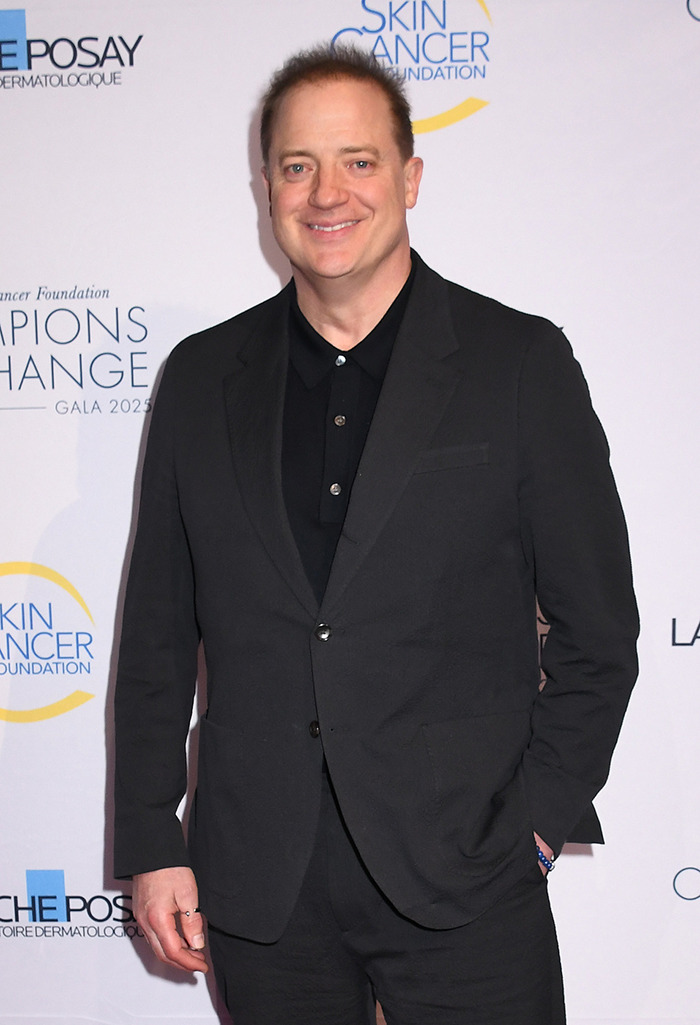 Brendan Fraser with a slimmed down physique wearing a black suit at a cancer gala event.