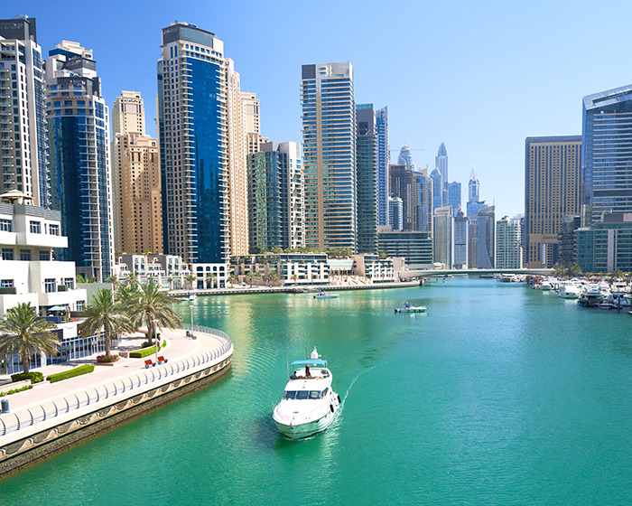 Dubai city skyline with high-rise buildings and boats on water, highlighting Dubai prison conditions concerns for woman jailed there. Dubai city skyline with high-rise buildings and boats on water, highlighting Dubai prison conditions concerns for woman jailed there.