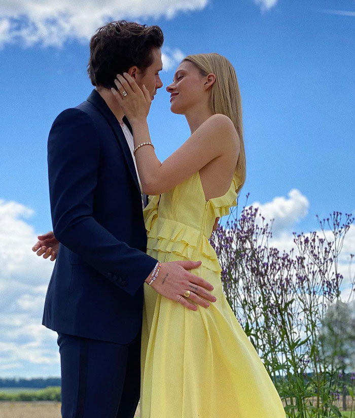 Nicola Peltz and her husband outdoors, highlighting Victoria Beckham's allegedly ruined son's wedding and emotional impact.