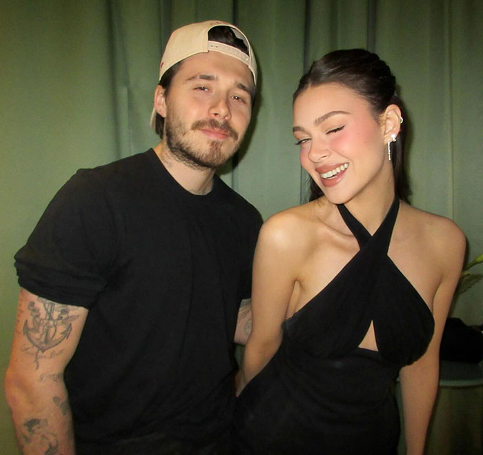 Brooklyn Beckham and Nicola Peltz posing together, linked to Victoria Beckham wedding controversy and emotional distress.