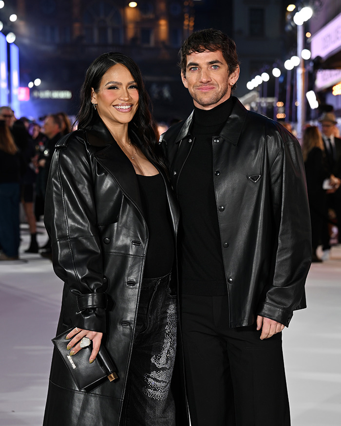 Cassie Ventura and her husband wearing matching black leather jackets at a public event with a crowd background. Cassie Ventura and her husband wearing matching black leather jackets at a public event with a crowd background.