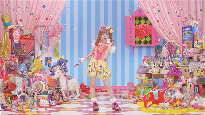 Colorful room filled with toys and collectibles with a young person in playful outfit, highlighting celebrities before their fame.