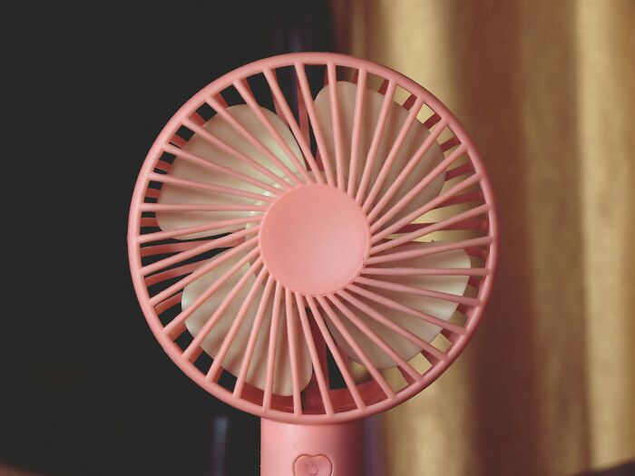 Portable pink mini fan with white blades, a tiny thing that made the trip better by providing personal cooling comfort.
