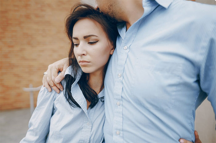 Girlfriend learns truth about boyfriend’s affair, looking sad while he embraces her in a quiet moment. Girlfriend learns truth about boyfriend’s affair, looking sad while he embraces her in a quiet moment.