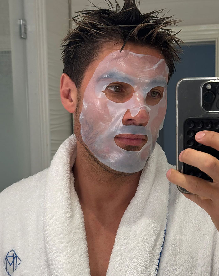 Man in a white robe taking a selfie wearing a clear facial mask, highlighting Kim Kardashian's hair stylist bulge in Cannes. Man in a white robe taking a selfie wearing a clear facial mask, highlighting Kim Kardashian's hair stylist bulge in Cannes.