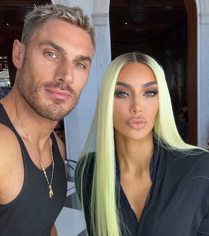 Kim Kardashian's hair stylist with styled hair posing alongside her in an indoor setting. Kim Kardashian's hair stylist with styled hair posing alongside her in an indoor setting.