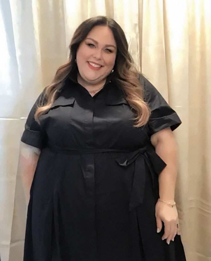 Chrissy Metz smiling and wearing a black dress, showcasing her slimmed-down look after 100lbs weight loss transformation.
