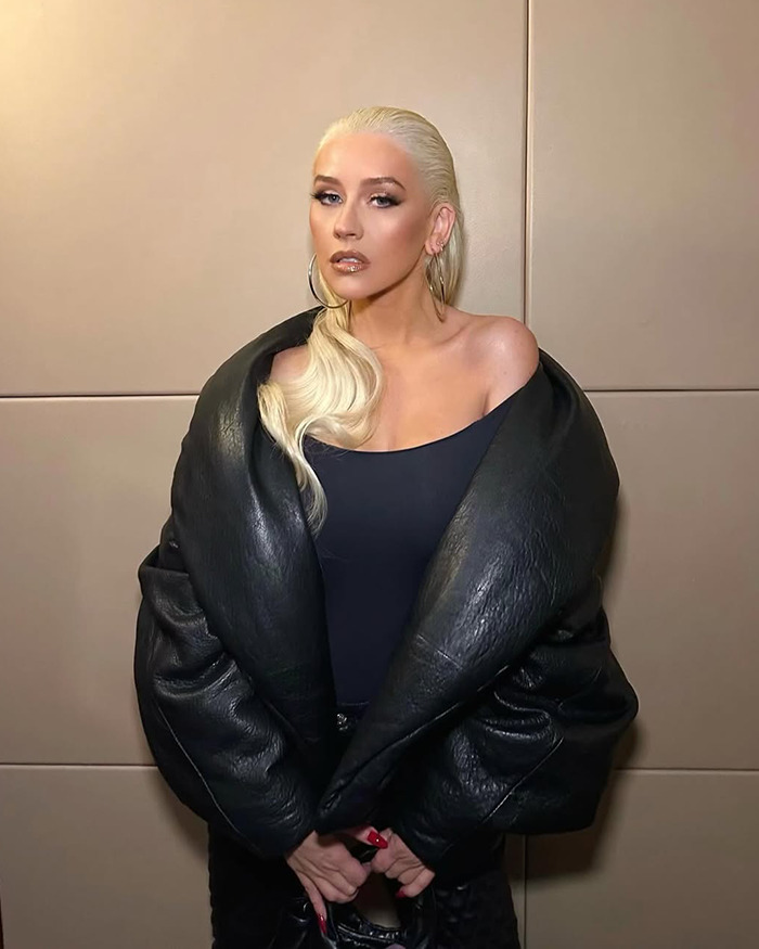 Christina Aguilera with platinum blonde hair wearing a black leather jacket sparking Ozempic and surgery rumors. Christina Aguilera with platinum blonde hair wearing a black leather jacket sparking Ozempic and surgery rumors.