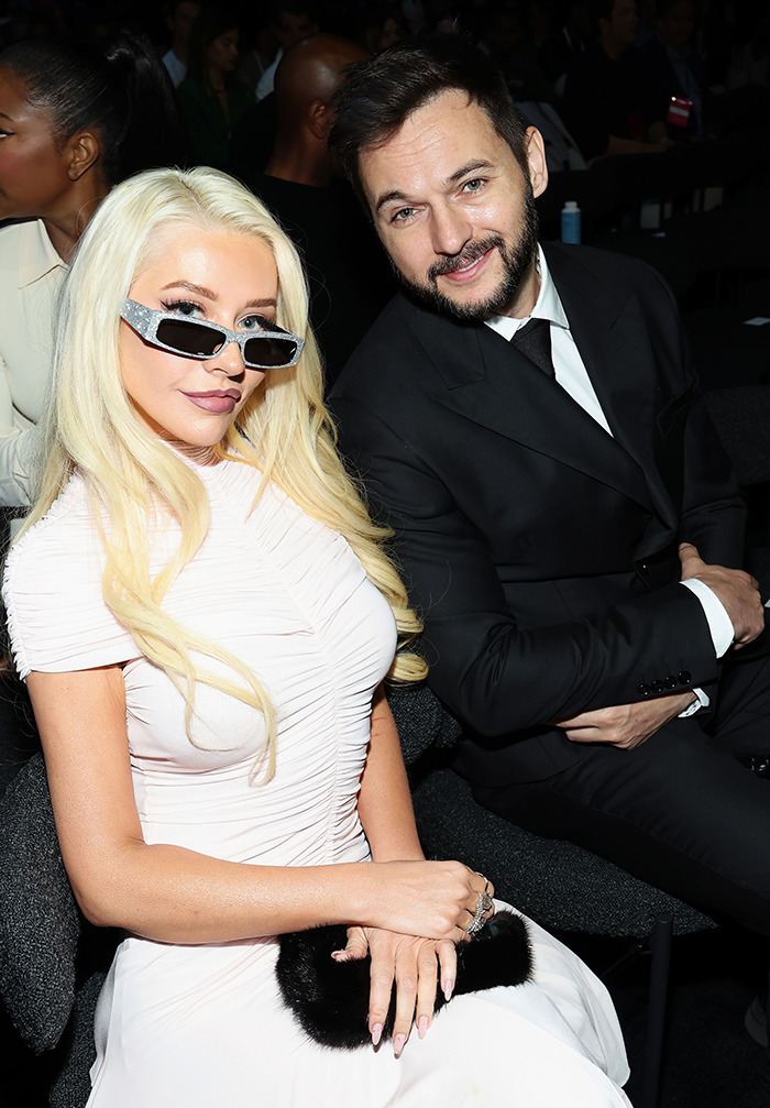 Christina Aguilera with blonde hair and sunglasses at event sparking Ozempic and surgery rumors in stylish white dress. Christina Aguilera with blonde hair and sunglasses at event sparking Ozempic and surgery rumors in stylish white dress.