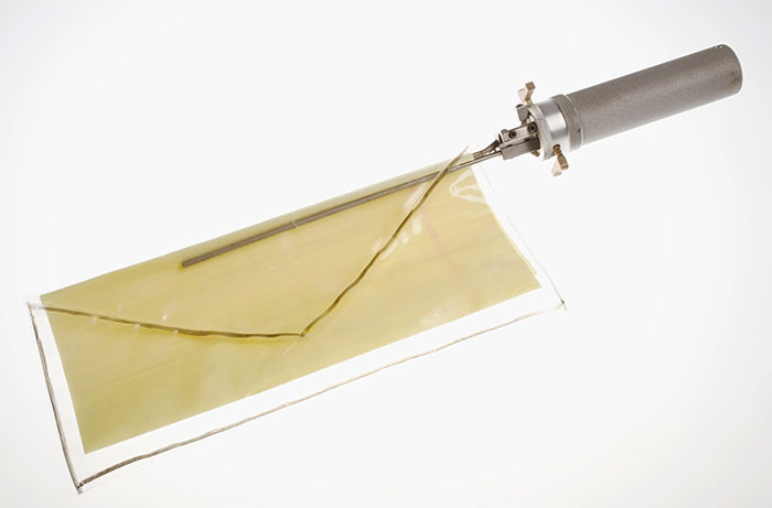 CIA spy technology example showing a covert listening device with a metallic handle and thin plastic film sensor.