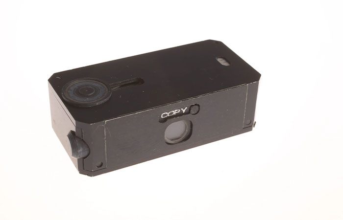 Small black spy camera device, an example of CIA spy technology showcasing human ingenuity and advanced surveillance tools.