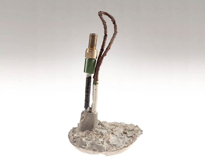 CIA spy technology example showing a compact hidden device with wires on a circular concrete base.