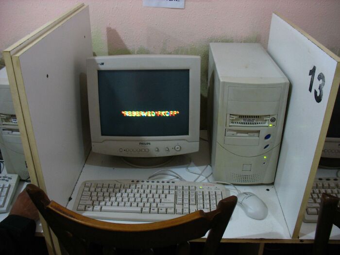 Vintage desktop computer with CRT monitor and keyboard in a cubicle, showcasing Gen X technology from the best of both worlds era.