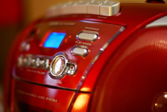Close-up of a vintage red stereo system representing Gen X technology blending analog and digital worlds.