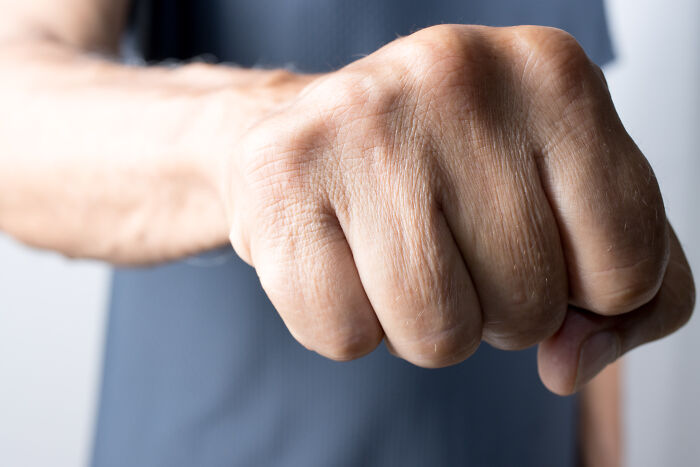 Close-up of a clenched fist symbolizing people who called off their wedding and shared their reasons.