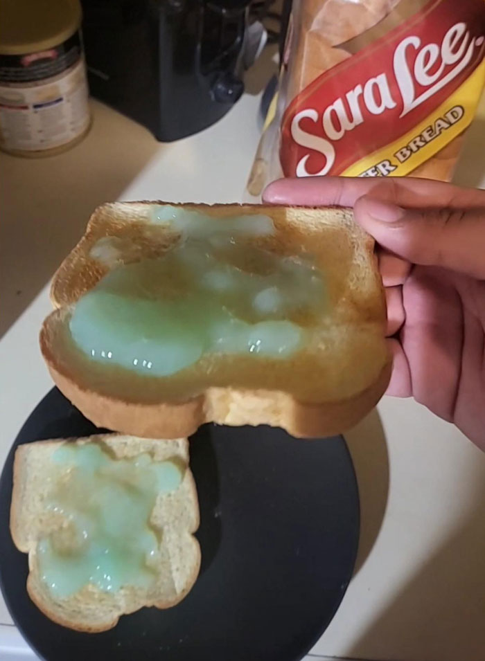Slice of bread with melted, miscolored spread, highlighting cooking fails and accidents in the kitchen.
