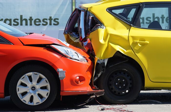 Two cars involved in a crash test with damage visible, illustrating people share companies bad list safety concerns.