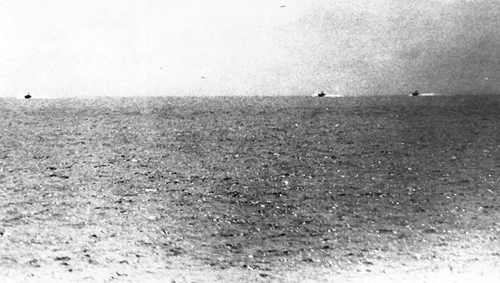 Black and white photo of a vast ocean with two distant ships, evoking mysterious craziest conspiracy theories.