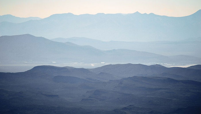 Mountain landscape shrouded in mist, representing mysterious and craziest conspiracy theories lurking in the dark corners of the internet.