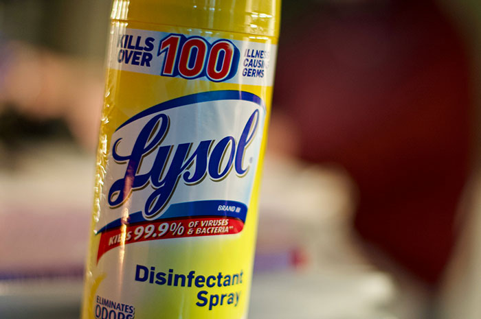 Close-up of Lysol disinfectant spray bottle, highlighting DIY medical treatment risks and misuse warnings.