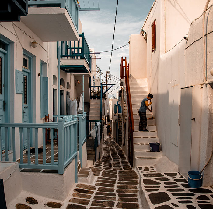 Narrow street in a Mediterranean village showing cultural differences in daily life and traditional architecture.