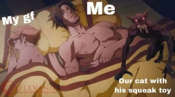 Anime-style couple in bed with a creepy cat holding a squeak toy, evoking adorable animals that may bring smiles.