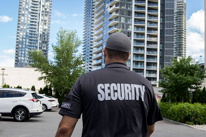 Security guard at a physical office building entrance managing access during a job visit attempt.