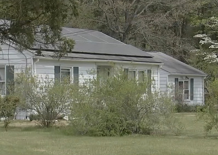 Suburban house with overgrown bushes in front, related to dad fatally beaten with metal bat incident.