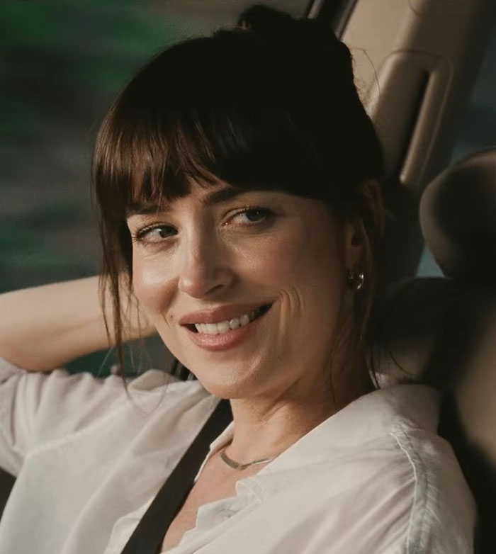 Dakota Johnson smiling inside a car, showcasing her natural look amid reactions to her sheer dress at Cannes event. Dakota Johnson smiling inside a car, showcasing her natural look amid reactions to her sheer dress at Cannes event.