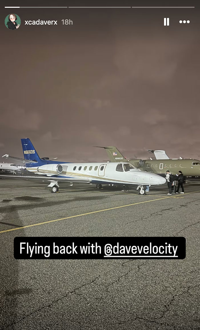 Private jet parked on runway at night with two people standing nearby, related to famous drummer plane crash.