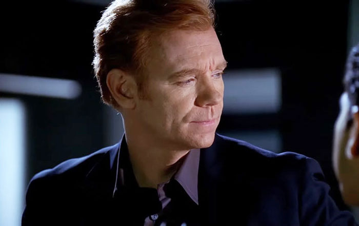 David Caruso, coolest TV cop, looking serious in a dark setting, making a rare appearance after a long hiatus.
