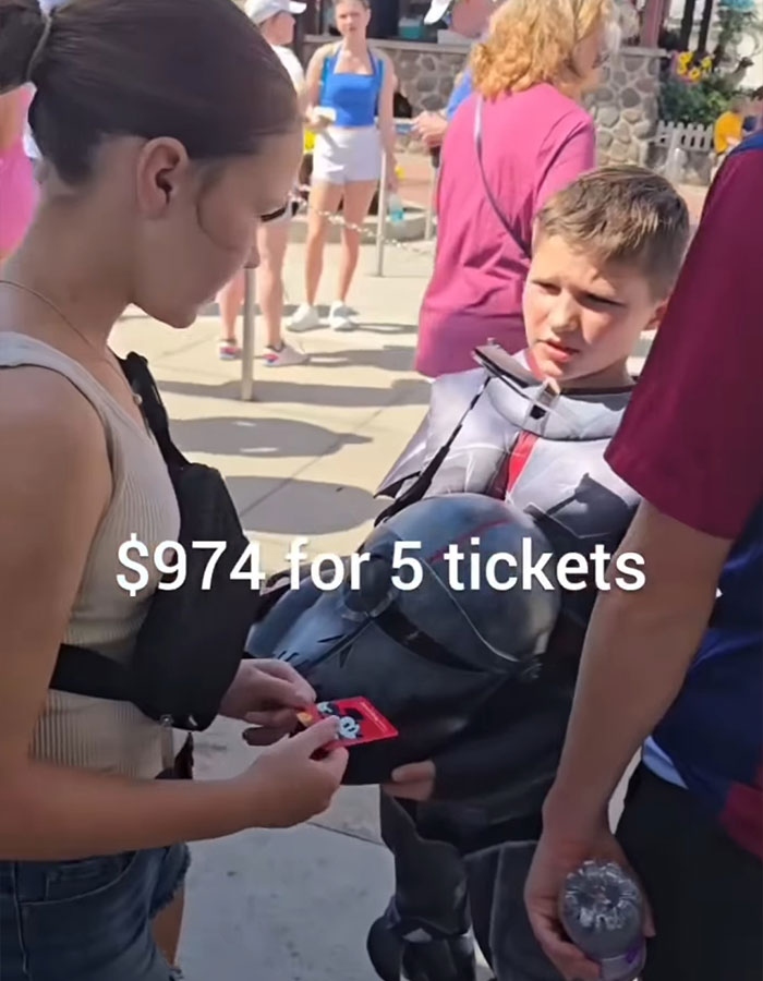 Family at Disney World discussing the high price of one-day tickets sparking debate over the cost of a family trip. Family at Disney World discussing the high price of one-day tickets sparking debate over the cost of a family trip.