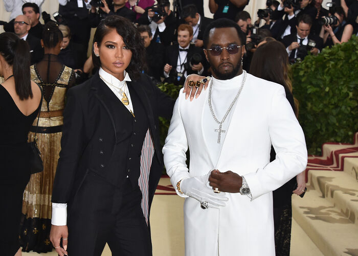 Diddy and a woman posing at an event, related to Diddy's ex-assistant recalling threats by rapper's staff.