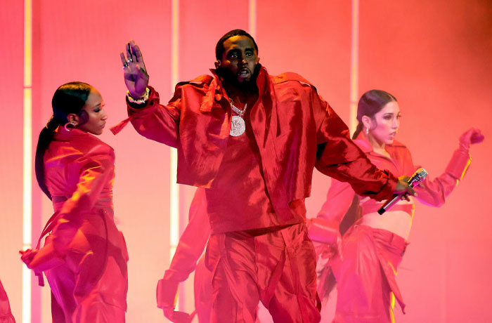 Diddy performing on stage with dancers, highlighting concerns about Diddy&rsquo;s net worth amid legal trouble and challenges.