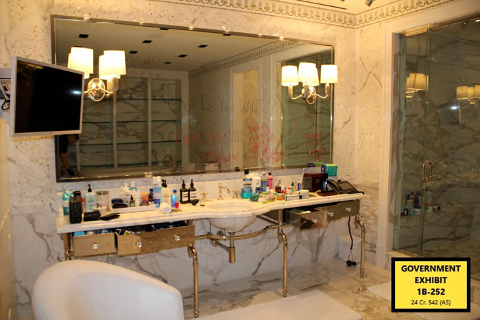 Bathroom counter with various personal items and disturbing messages on the mirror from Diddy trial Miami mansion raid.