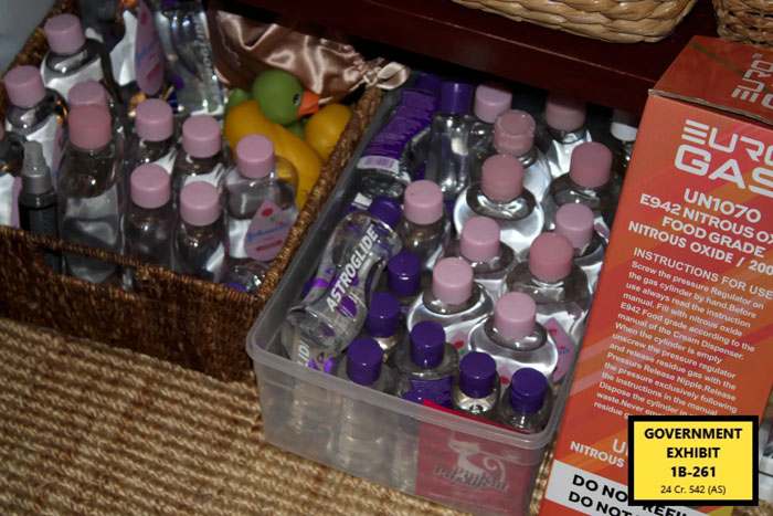 Plastic bottles and nitrous oxide canisters displayed as disturbing items found in Miami mansion during Diddy trial raid.