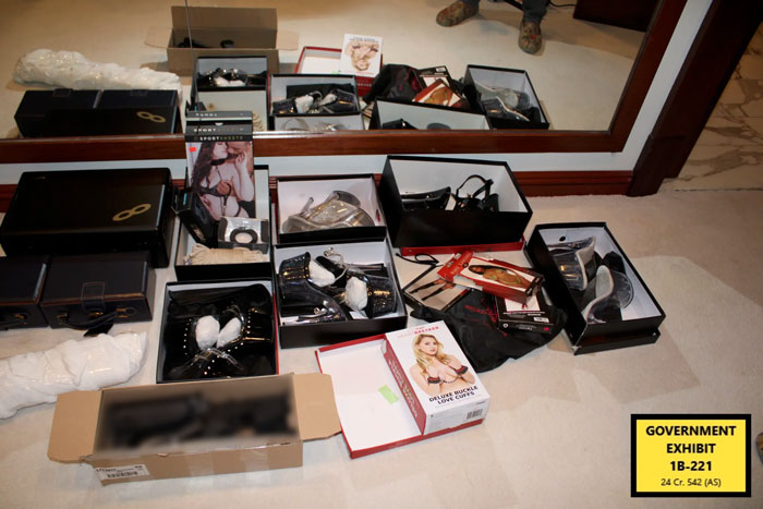 Boxes of fetish and adult items displayed on floor during Miami mansion raid in Diddy trial as government exhibit evidence.