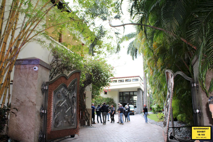 Gated mansion entrance with police and people gathered outside, related to court case revealing disgusting eating habits. Gated mansion entrance with police and people gathered outside, related to court case revealing disgusting eating habits.