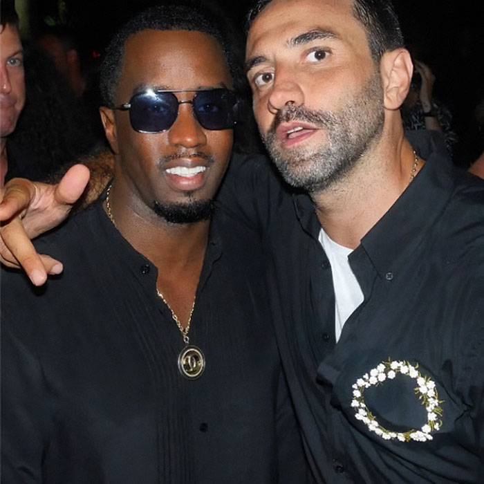 Diddy and friend posing at wild star-studded party in Ibiza, with photos recently revealed amid trial controversy.
