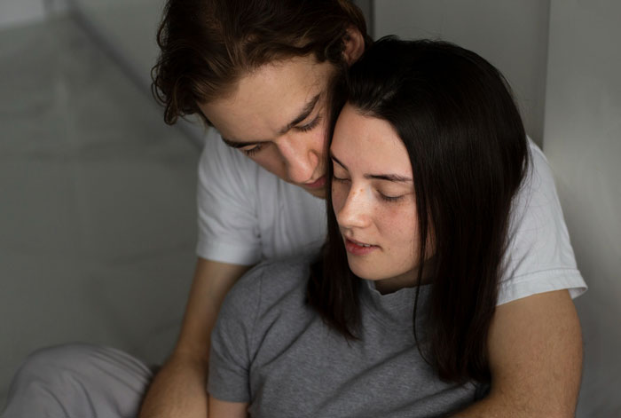 Young couple embracing indoors, illustrating a cousin betrayed lady scenario involving an affair with her ex partner.