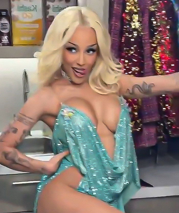 Doja Cat wearing a revealing teal dress on the red carpet, showing confidence amid plastic surgery mishap rumors. Doja Cat wearing a revealing teal dress on the red carpet, showing confidence amid plastic surgery mishap rumors.