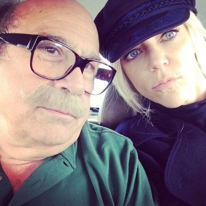 Older man with glasses and mustache and a woman in a black hat take a selfie for Instagram posts celebrities shared.
