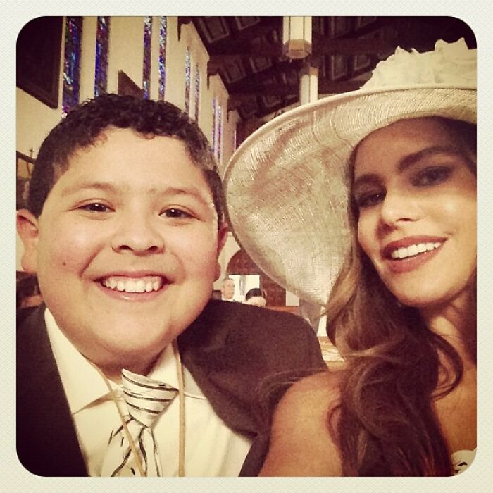 Young boy and woman wearing a large hat smiling in a selfie, an example of Instagram posts celebrities shared way back in the day