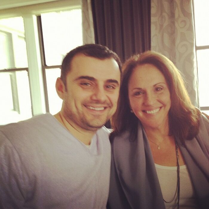 Two people smiling together indoors in a casual setting, illustrating Instagram posts celebrities shared way back in the day.